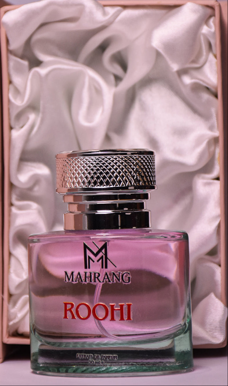 Perfume bottle labeled 'Mahrang Roohi' with a decorative box in the background